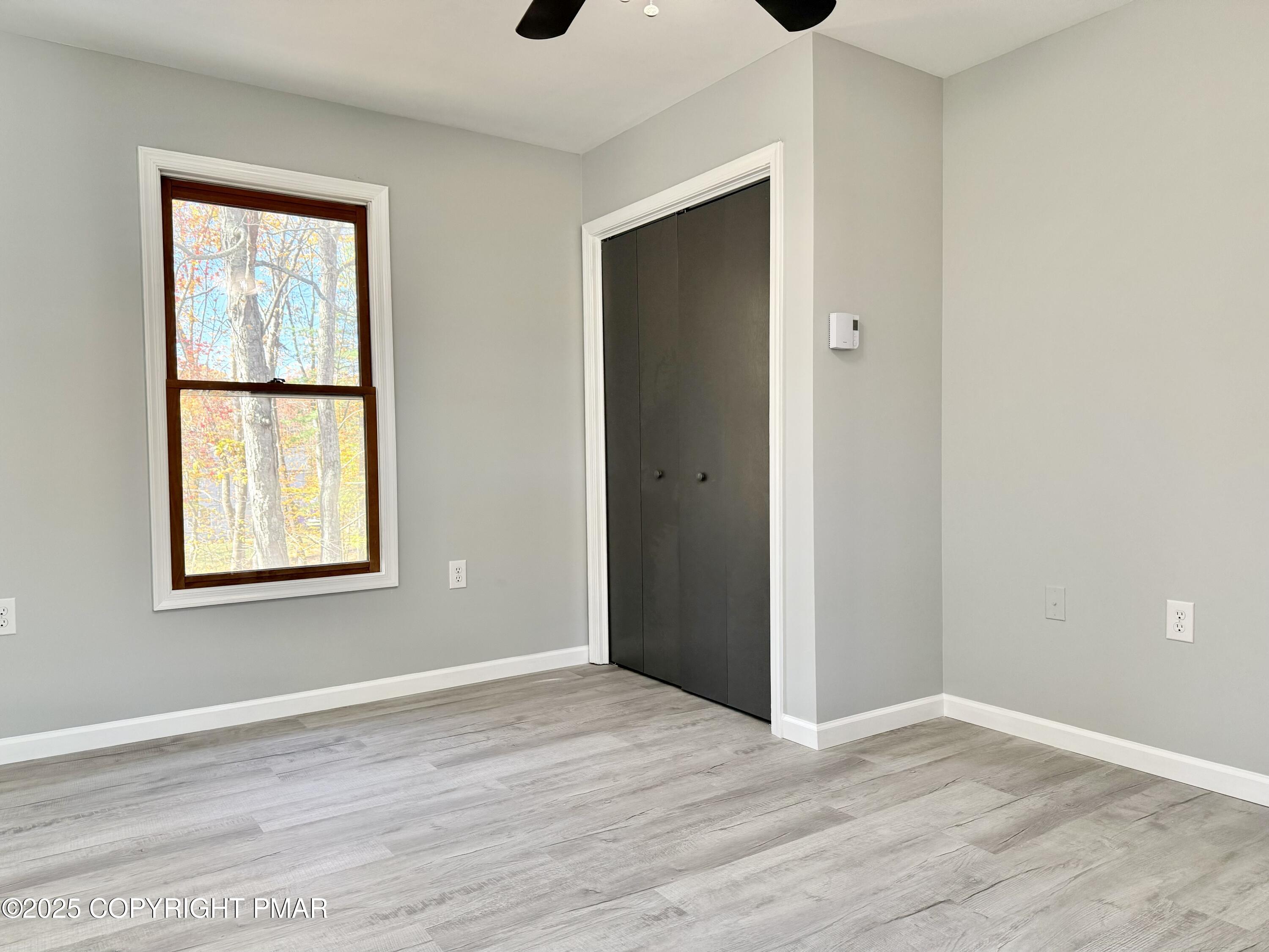 104 Dunchurch Drive Bushkill, PA 18324 - Photo 26 of 35 a view of an empty room with wooden floor and a window