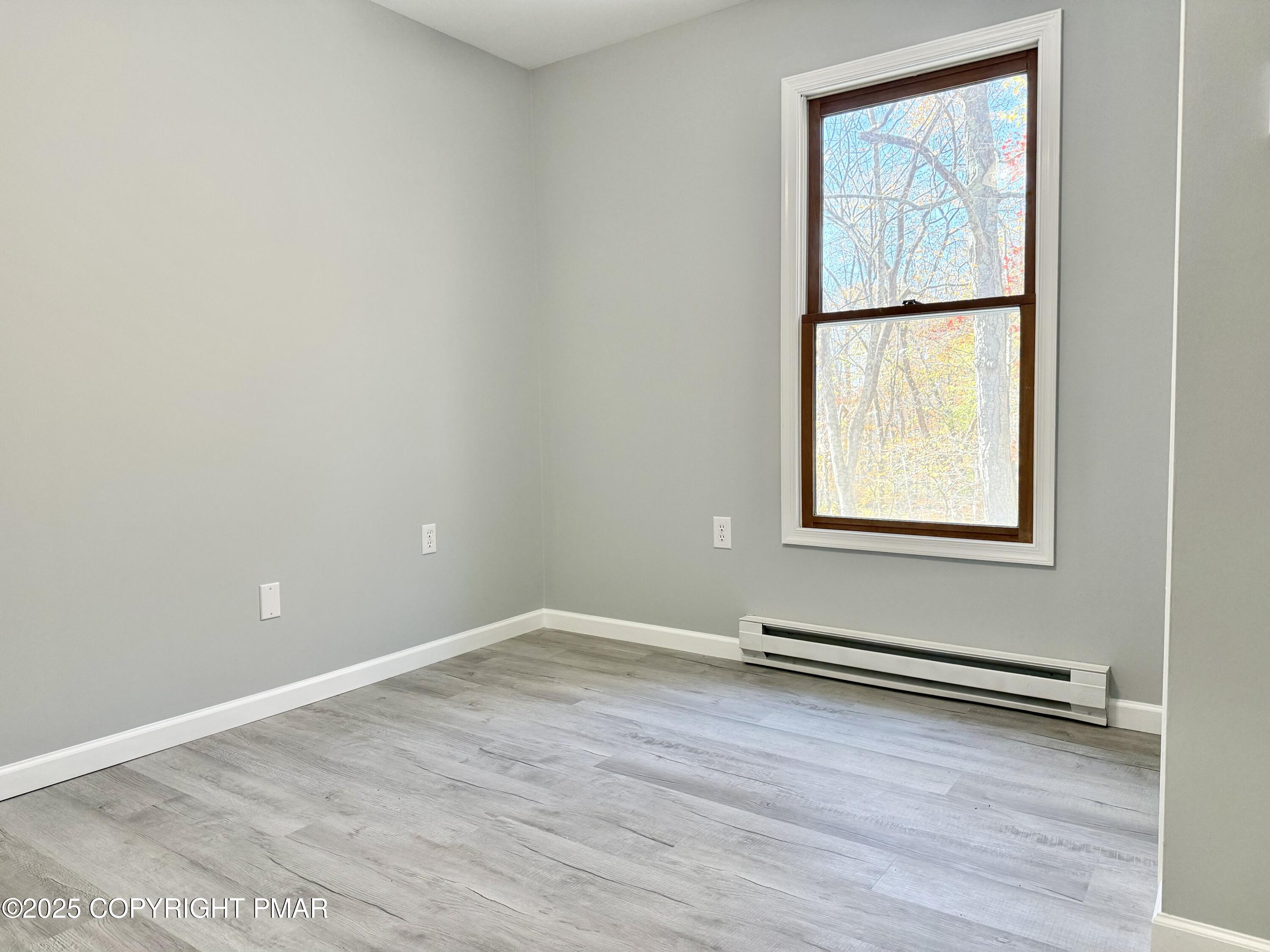 104 Dunchurch Drive Bushkill, PA 18324 - Photo 27 of 35 an empty room with wooden floor and windows