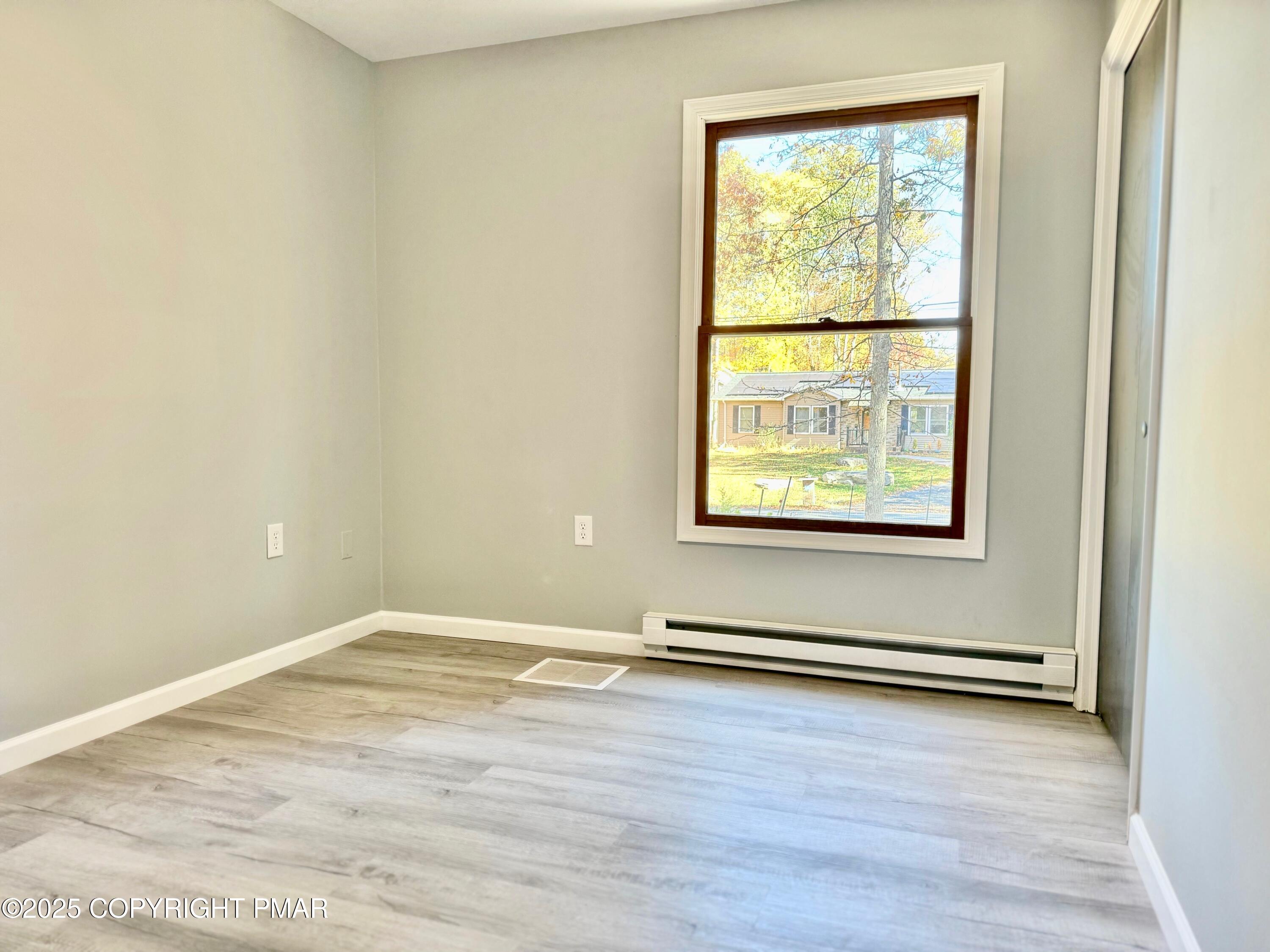 104 Dunchurch Drive Bushkill, PA 18324 - Photo 30 of 35 an empty room with wooden floor and windows