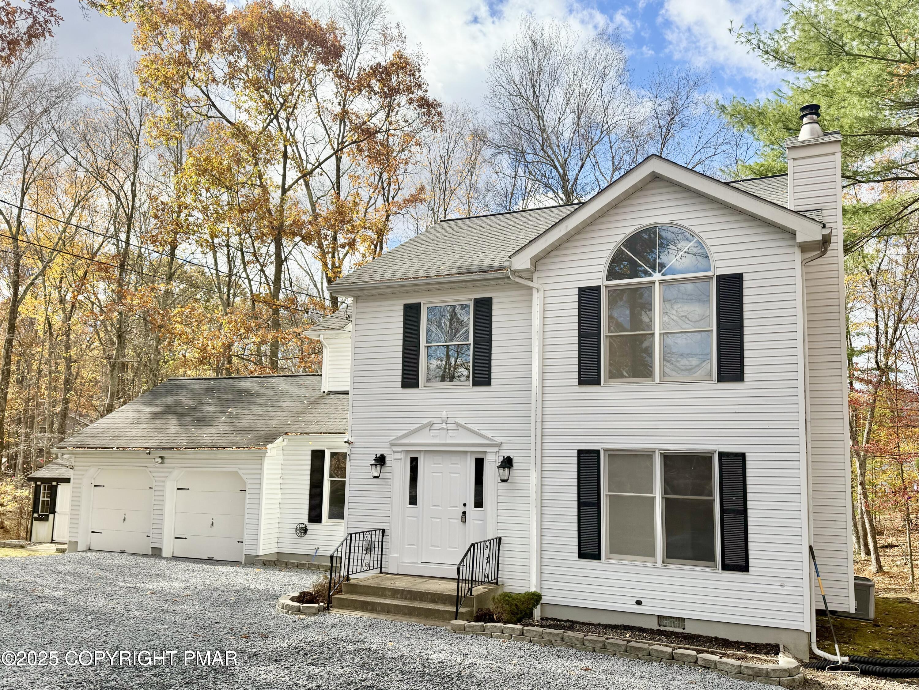 104 Dunchurch Drive Bushkill, PA 18324 - Photo 33 of 35 a view of a white house with large windows next to a road