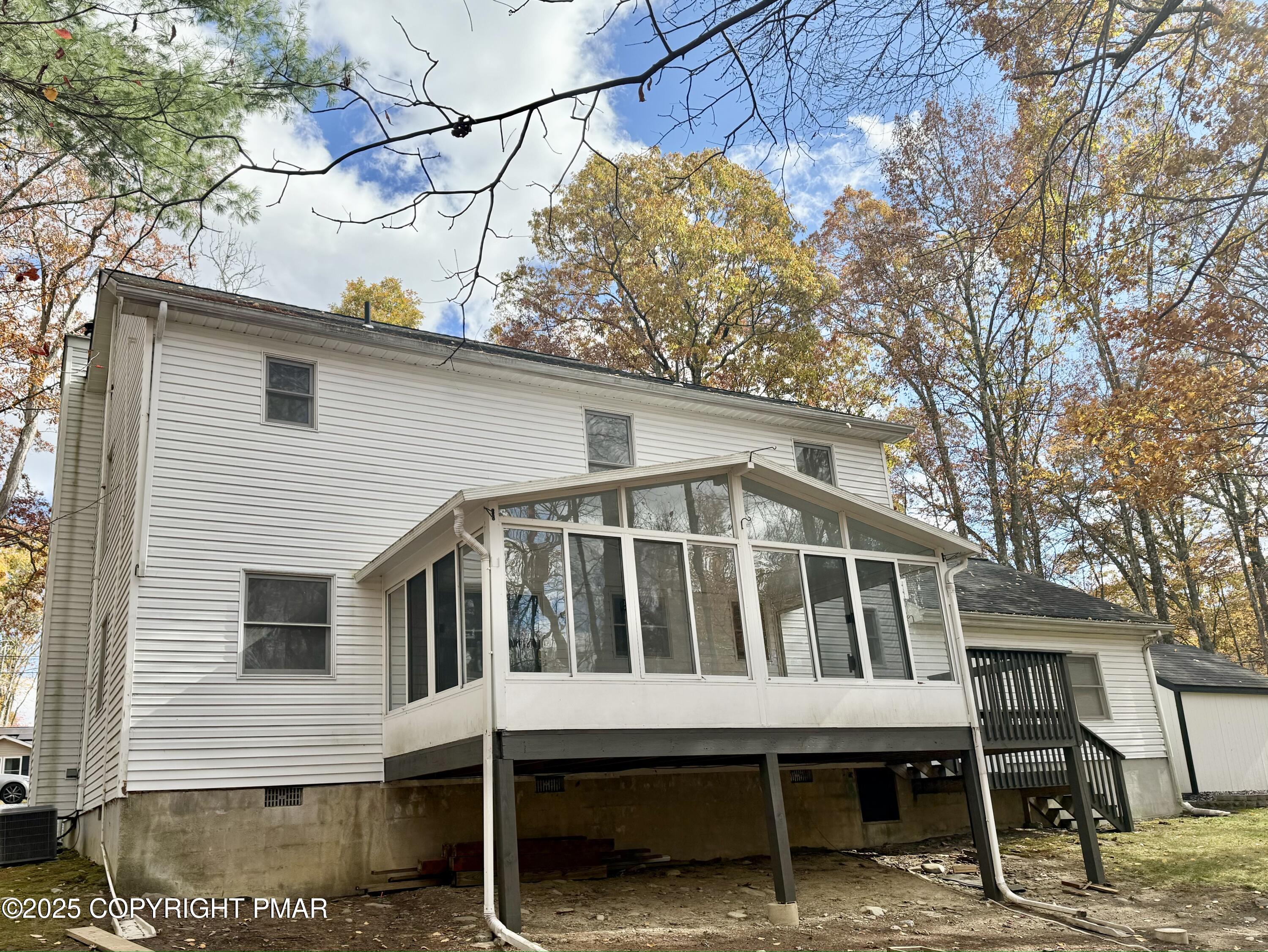 104 Dunchurch Drive Bushkill, PA 18324 - Photo 34 of 35 a white house with a large window and wooden fence