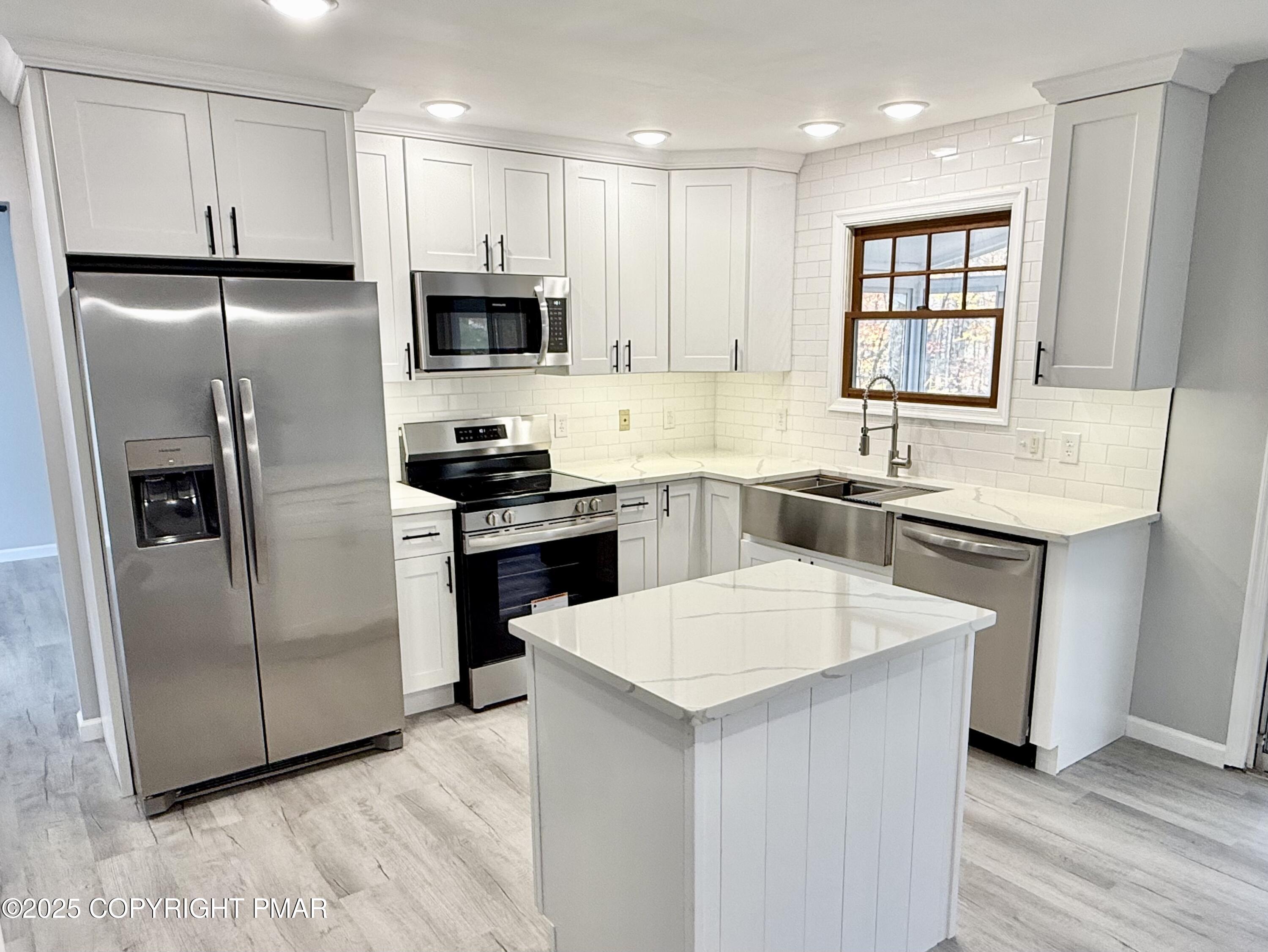 104 Dunchurch Drive Bushkill, PA 18324 - Photo 7 of 35 a kitchen with stainless steel appliances a refrigerator sink and microwave