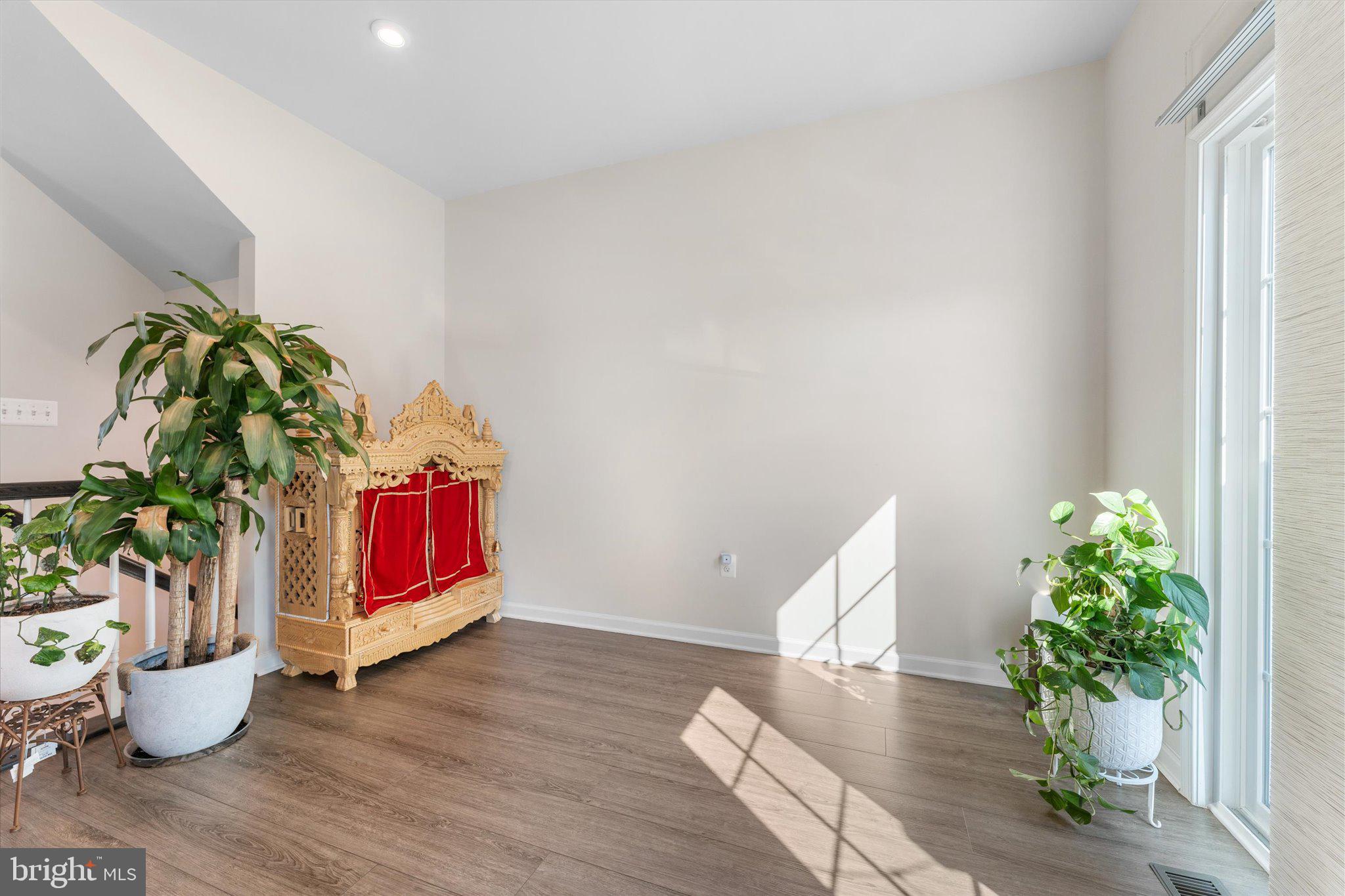 1776 Scenic Loop Culpeper, VA 22701 - Photo 11 of 36 a room with a potted plant and wooden floor