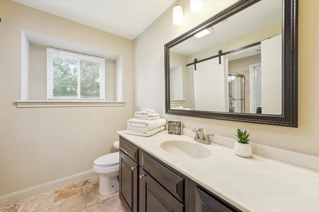 a view of a room with wooden floor and potted plant