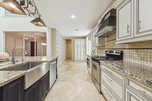 a living room with furniture a fireplace and a floor to ceiling window