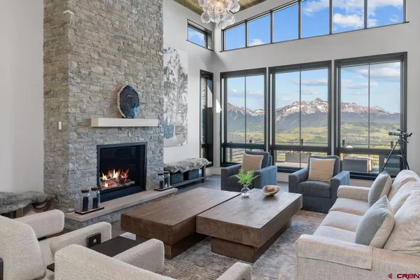 a living room with furniture large window and a fireplace