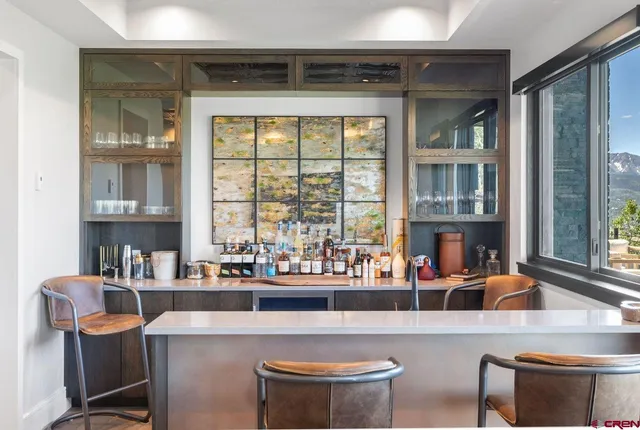 a dining table with chairs and window