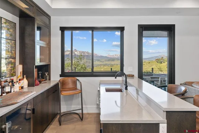 a large window in a kitchen with granite countertop a large window and a sink