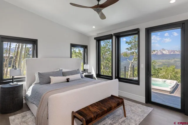 a bedroom with a large bed and a balcony view