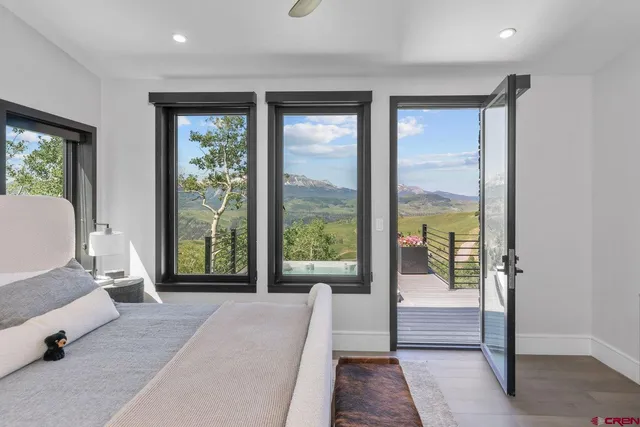 a bed room with a bed and a large window