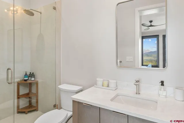 a bathroom with a sink toilet and mirror