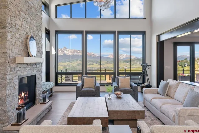 a living room with furniture large window and a fireplace