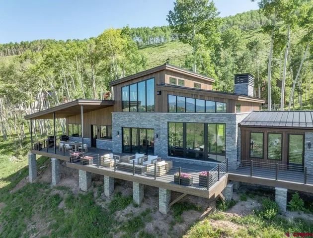 a backyard of a house with yard fire pit and outdoor seating