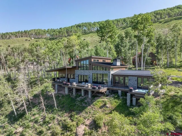 a backyard of a house with yard and outdoor seating