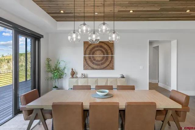 a dining room with furniture a chandelier and window