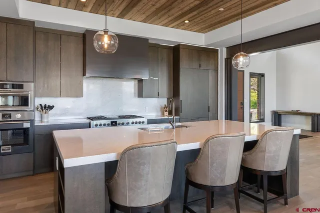 a kitchen with sink a table and chairs