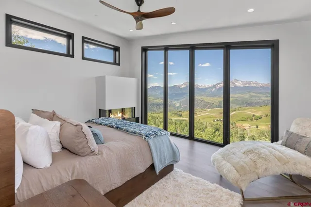 a bedroom with a large bed and a large window