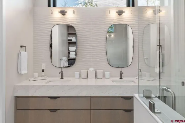 a bathroom with a double vanity sink and a mirror