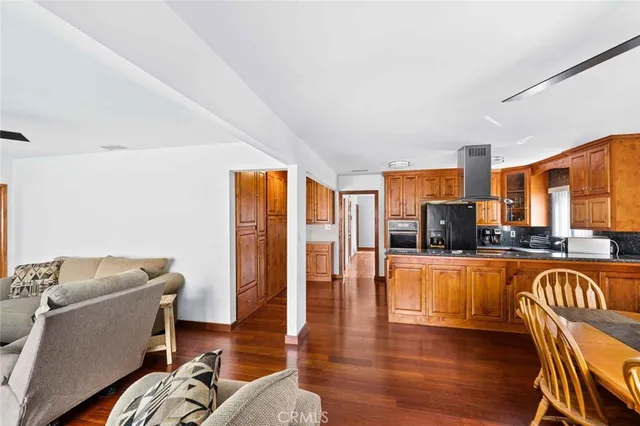 a kitchen with stainless steel appliances a stove a sink dishwasher and cabinets with wooden floor