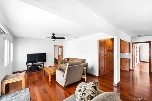 a living room with furniture window and wooden floor