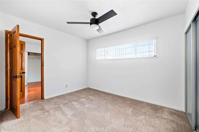 a view of empty room with ceiling fan