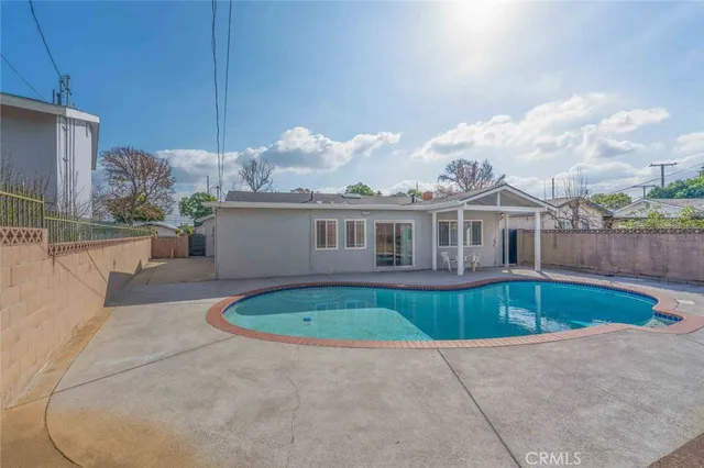 a front view of house with yard and swimming pool