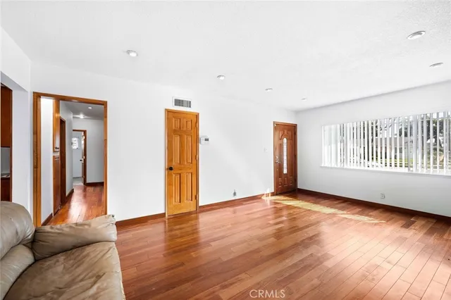 a view of an empty room with glass door