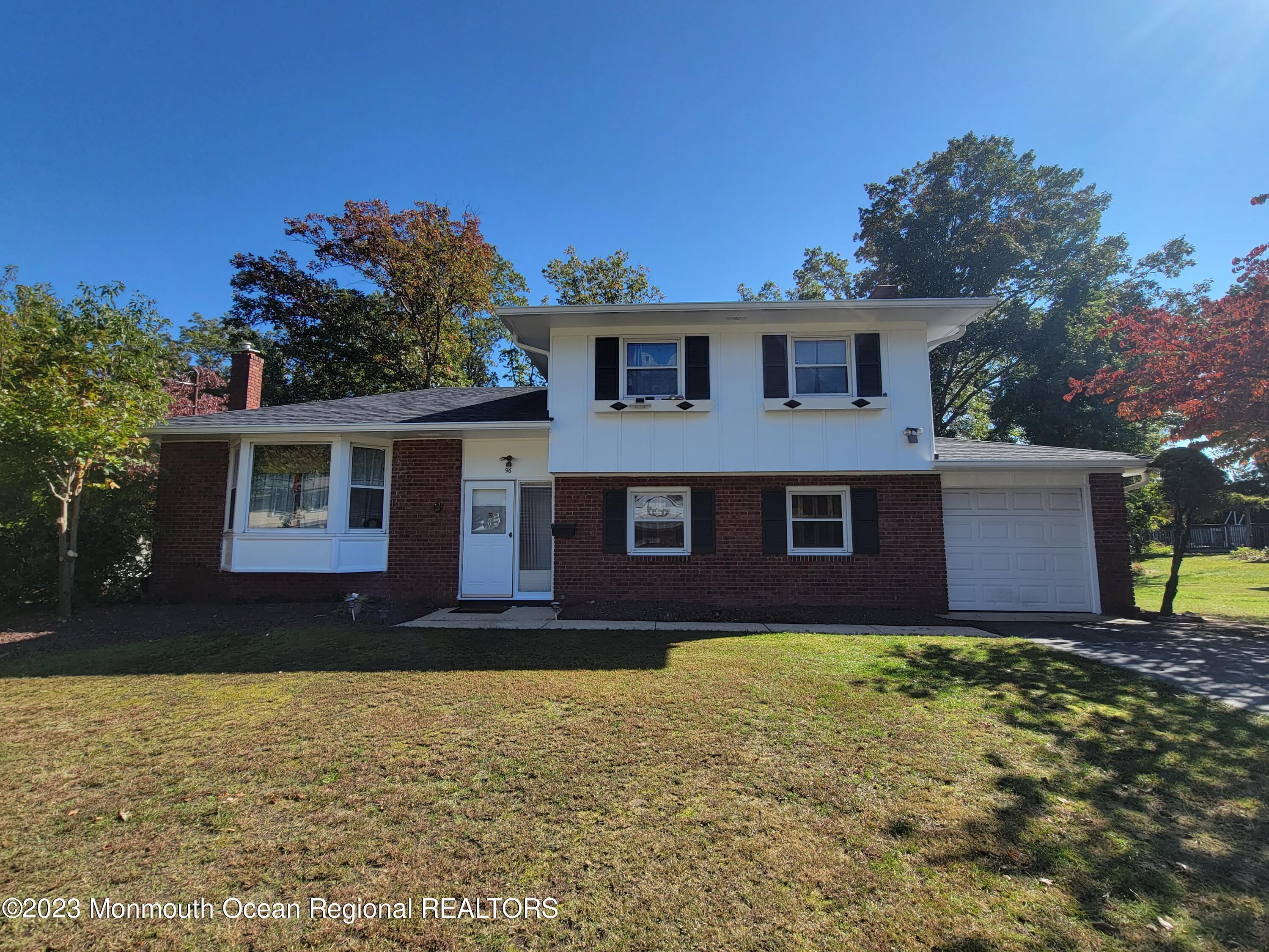 96 Newbury Road Howell, NJ 07731 - Photo 2 of 12 a front view of a house with a yard