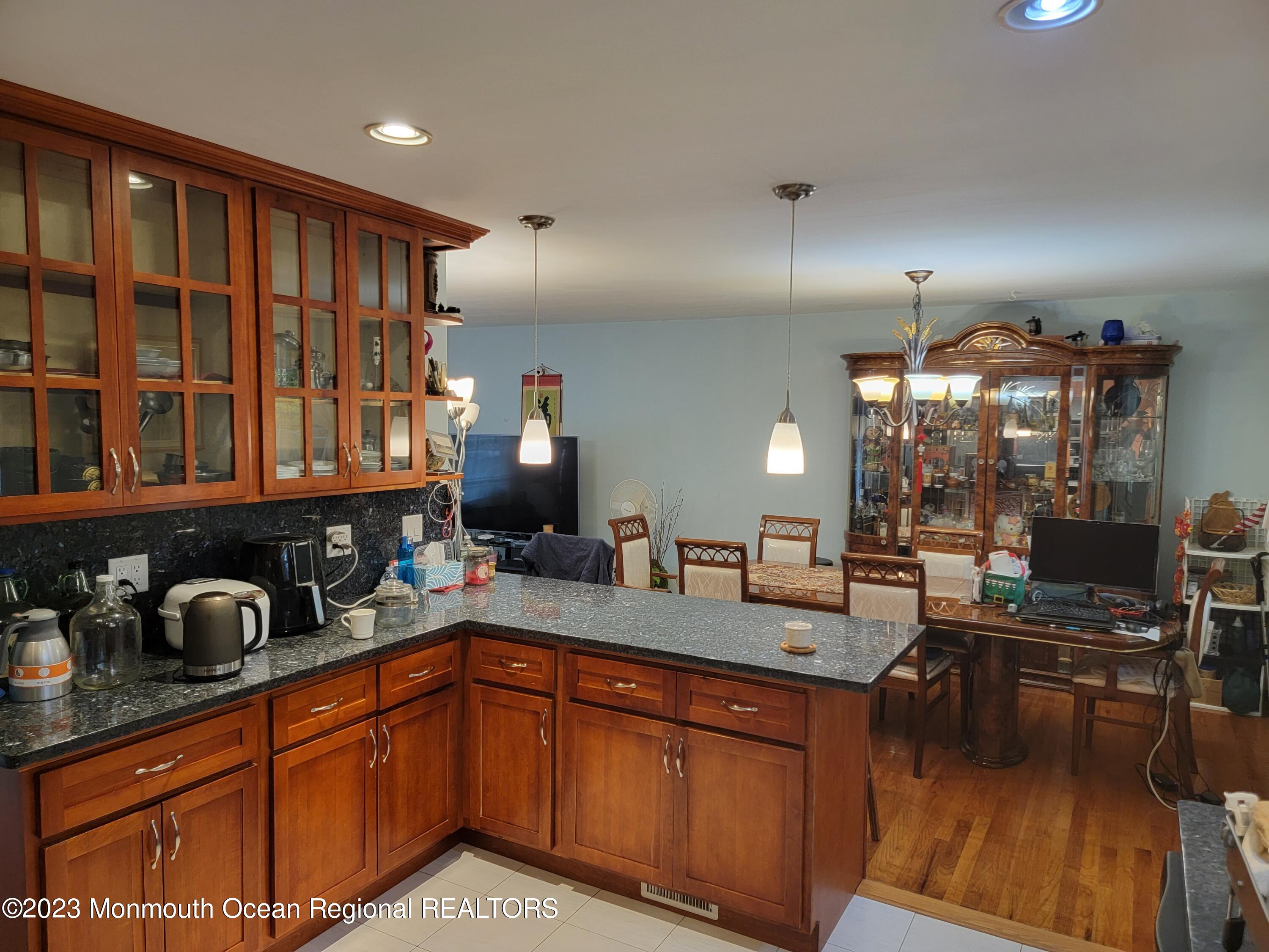 96 Newbury Road Howell, NJ 07731 - Photo 6 of 12 a kitchen with granite countertop a sink stove and cabinets