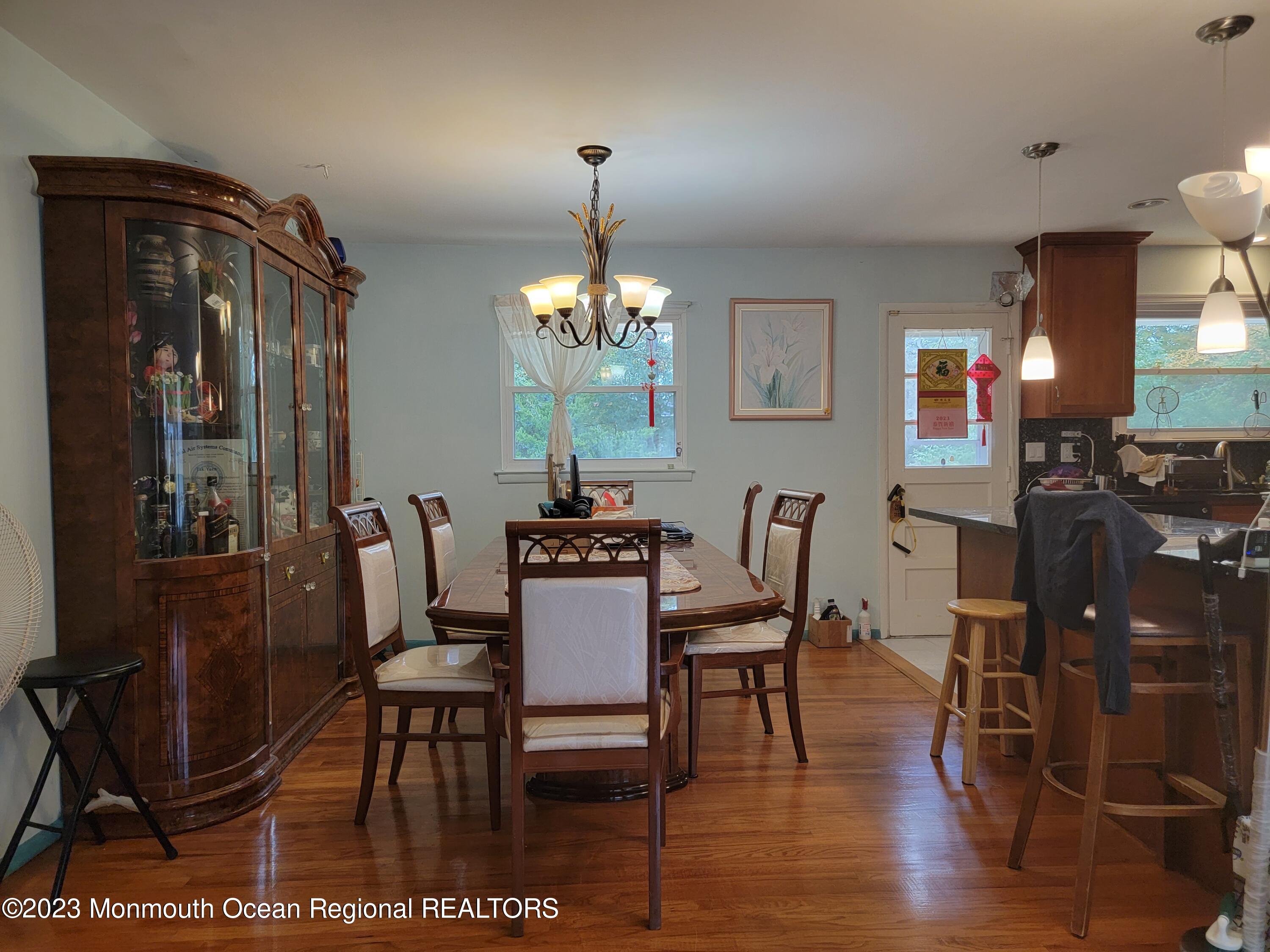 96 Newbury Road Howell, NJ 07731 - Photo 7 of 12 a dining room with furniture a chandelier and wooden floor