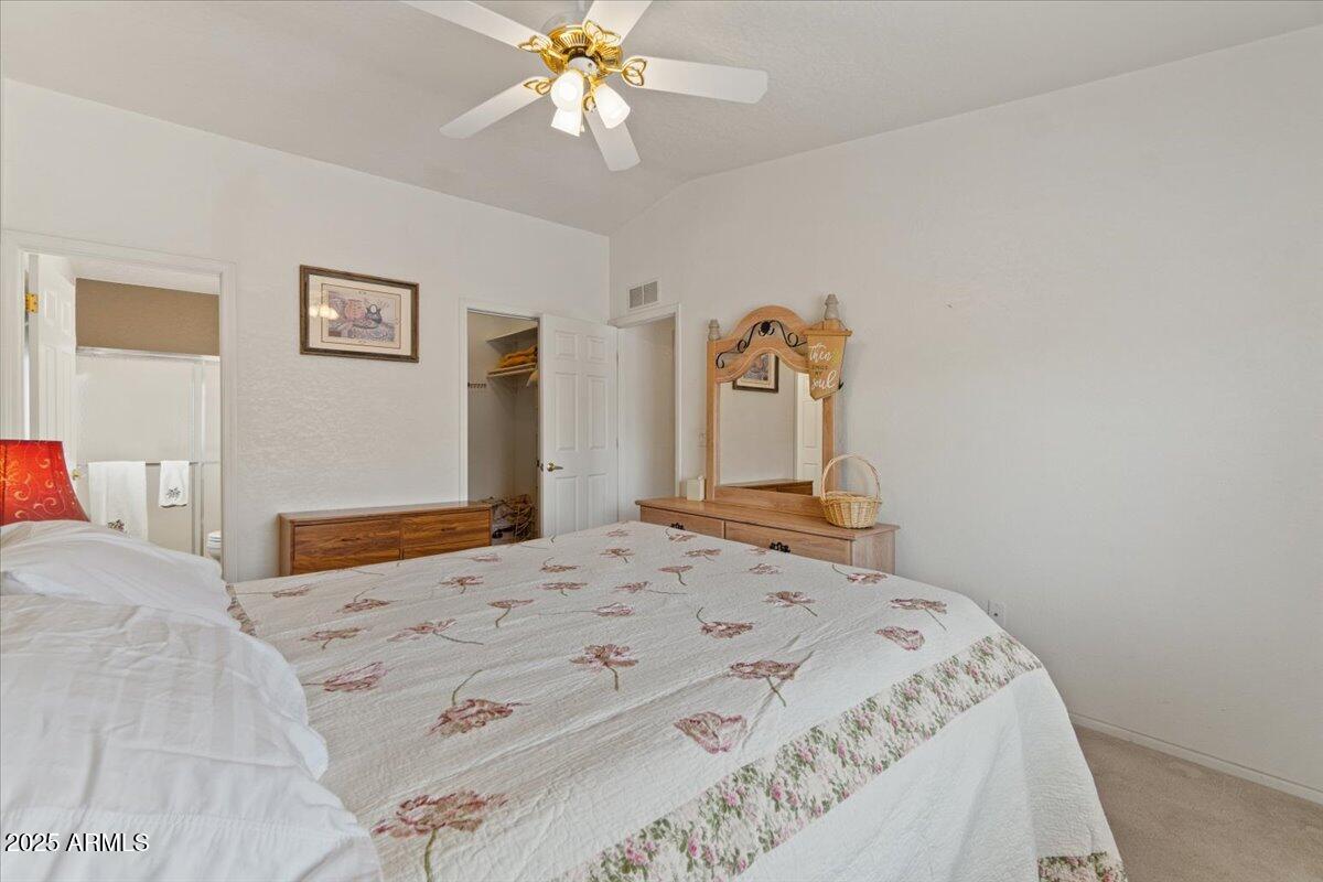 2054 North Thornton Road, Unit 125 Casa Grande, AZ 85122 - Photo 13 of 26 a bedroom with a bed and a chandelier