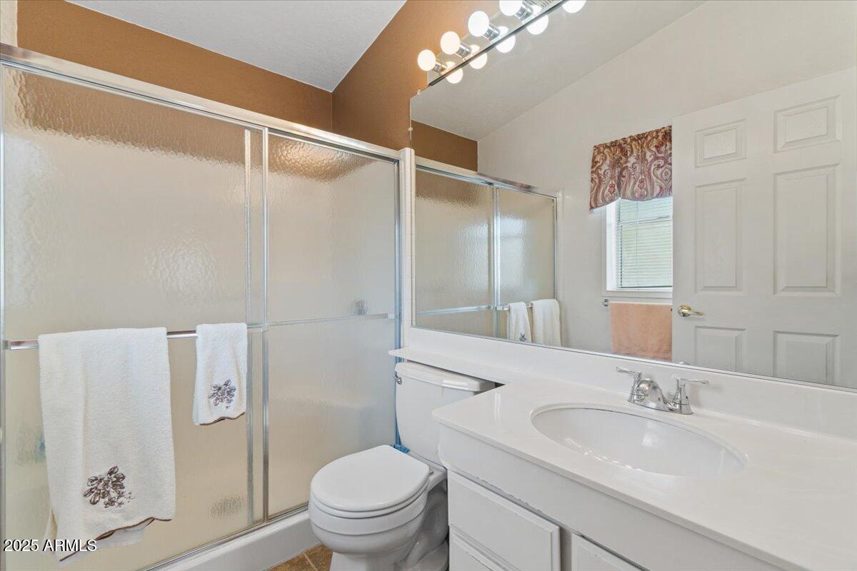 2054 North Thornton Road, Unit 125 Casa Grande, AZ 85122 - Photo 14 of 26 a bathroom with a sink a toilet and a large mirror