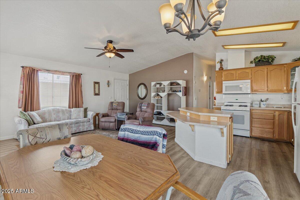 2054 North Thornton Road, Unit 125 Casa Grande, AZ 85122 - Photo 3 of 26 a living room with furniture kitchen view and a chandelier