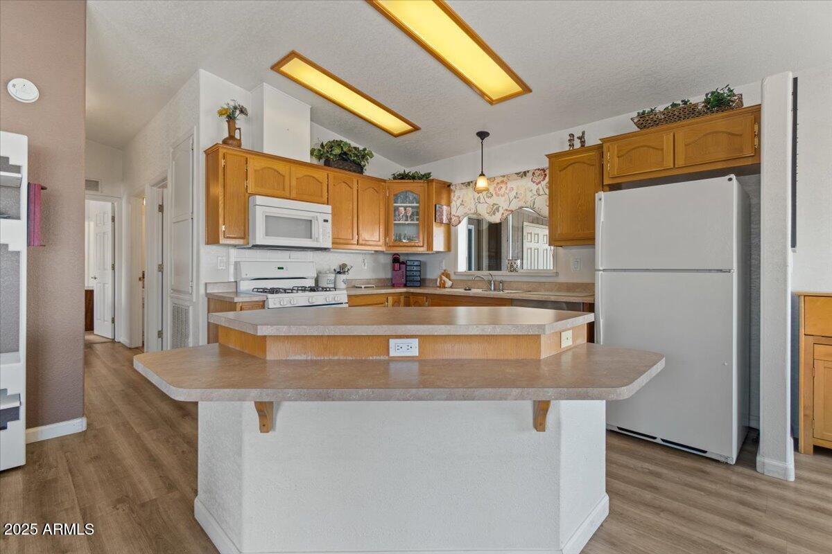 2054 North Thornton Road, Unit 125 Casa Grande, AZ 85122 - Photo 8 of 26 a kitchen with stainless steel appliances granite countertop a sink and a refrigerator