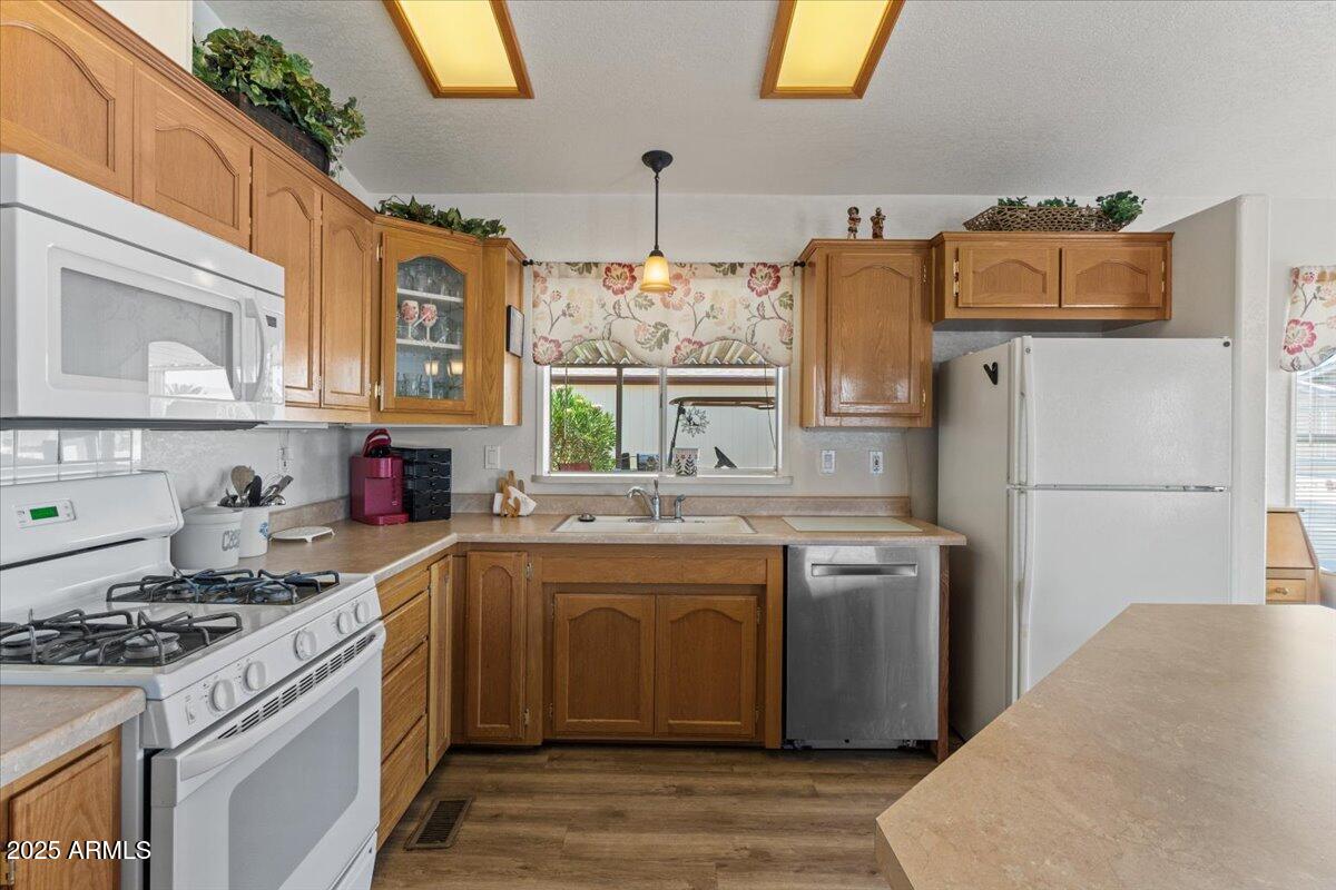 2054 North Thornton Road, Unit 125 Casa Grande, AZ 85122 - Photo 9 of 26 a kitchen with a sink stove and refrigerator