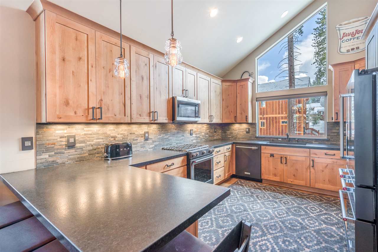 10427 Winter Creek Loop Truckee, CA 96161 - Photo 8 of 21 a kitchen with stainless steel appliances granite countertop a sink a stove counter space and cabinets