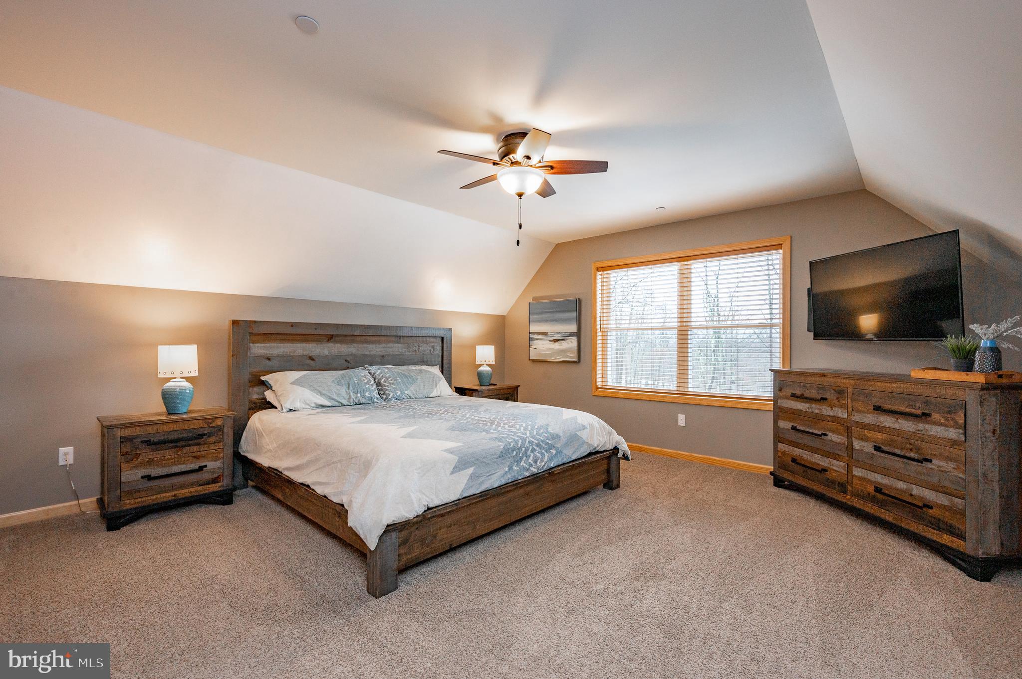 226 Wisp Adventure Road McHenry, MD 21541 - Photo 54 of 67 a bedroom with a bed and a flat screen tv
