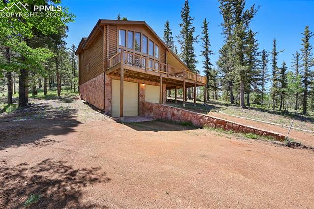 337 Porphry Road Florissant, CO 80816 - Photo 4 of 26 Rear view of house featuring a garage