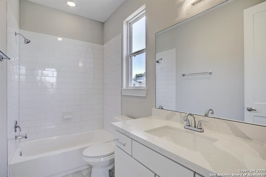 2502 Hadley Street Houston, TX 77003 - Photo 17 of 23 a bathroom with a bathtub shower sink vanity mirror and toilet
