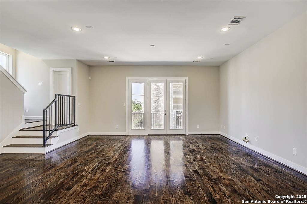 2502 Hadley Street Houston, TX 77003 - Photo 5 of 23 a view of an empty room with wooden floor and a window