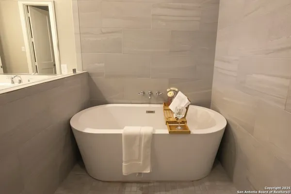 a bathroom with a shower sink and mirror
