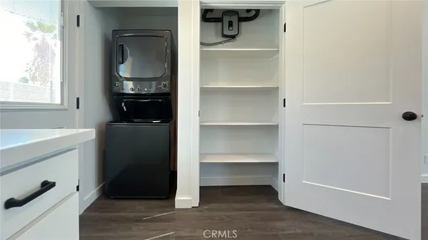 a kitchen with stainless steel appliances white cabinets and a refrigerator