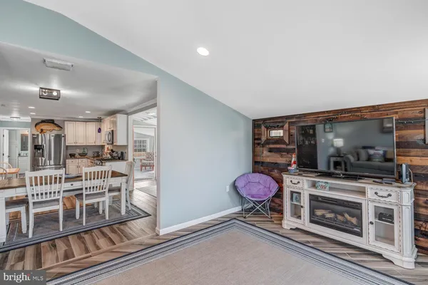 a living room with hard wood flooring and white walls