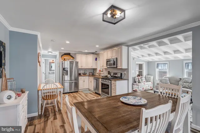 a kitchen with stainless steel appliances a refrigerator a sink a stove top oven a refrigerator and cabinets