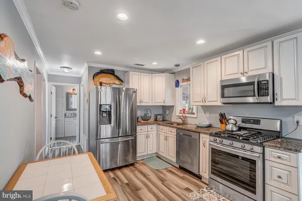 a living room with furniture a rug and a table