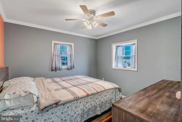 a bedroom with a large bed and a large mirror