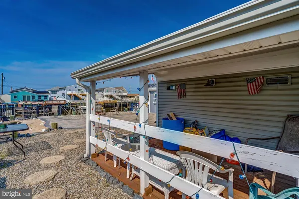 a view of balcony with two chairs and potted plants