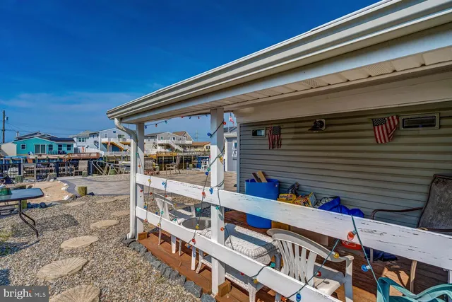 a view of balcony with two chairs and potted plants