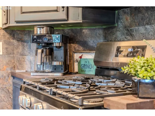 a stove top oven sitting inside of a kitchen