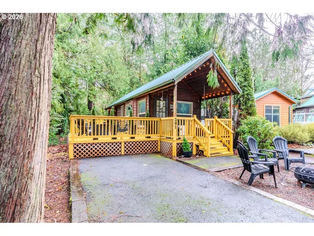 a view of a house with backyard and sitting area
